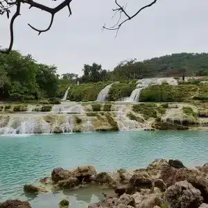 Scenic view of Salalah excursions with waterfalls, mountains, and desert landscapes