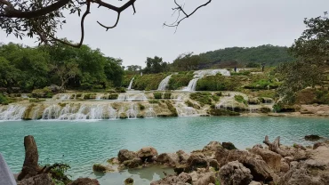 Scenic view of Salalah excursions with waterfalls, mountains, and desert landscapes